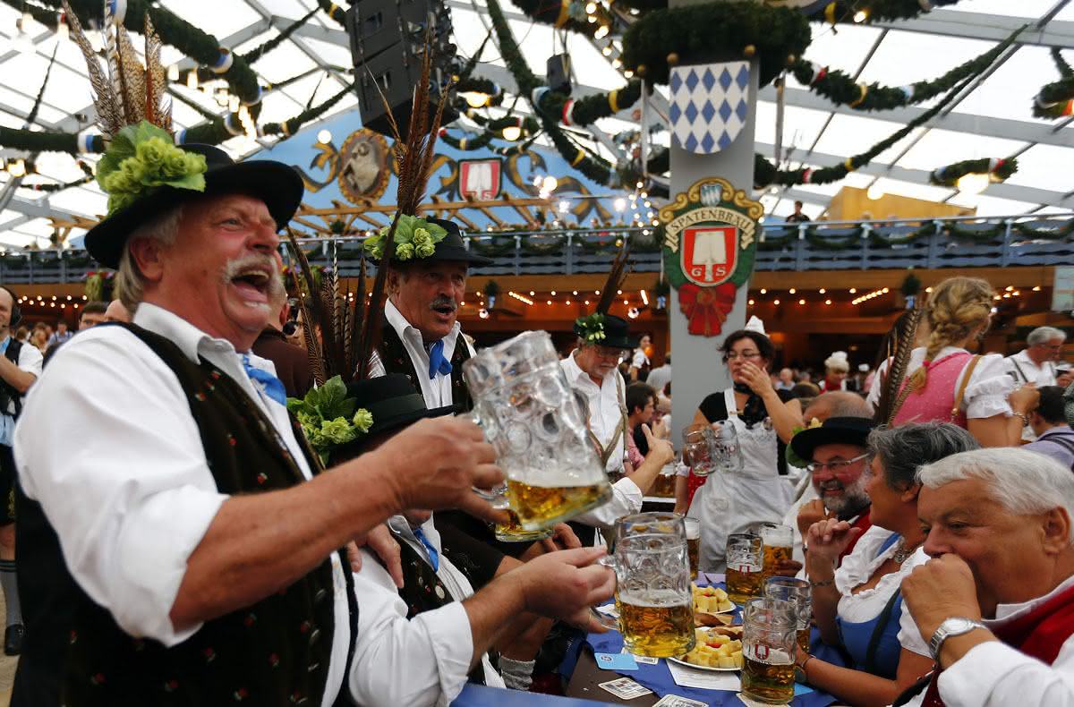 Revellers salute with beer after the opening of the 179th Oktoberfest